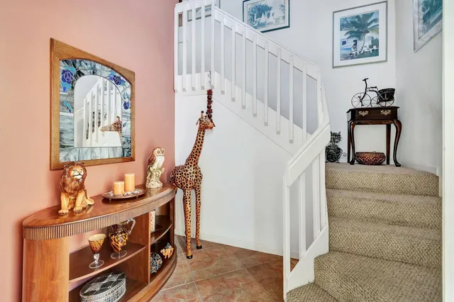a living room with furniture and a baby crib