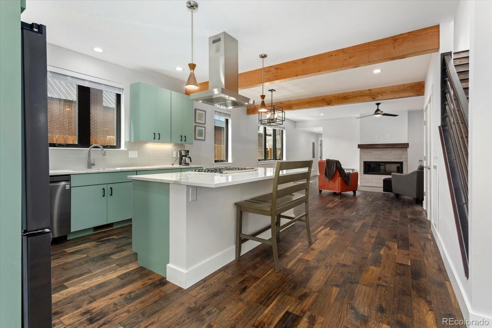 1036 H Street Salida, CO 81201 - Photo 19 of 50 a room with kitchen island a sink and wooden floor