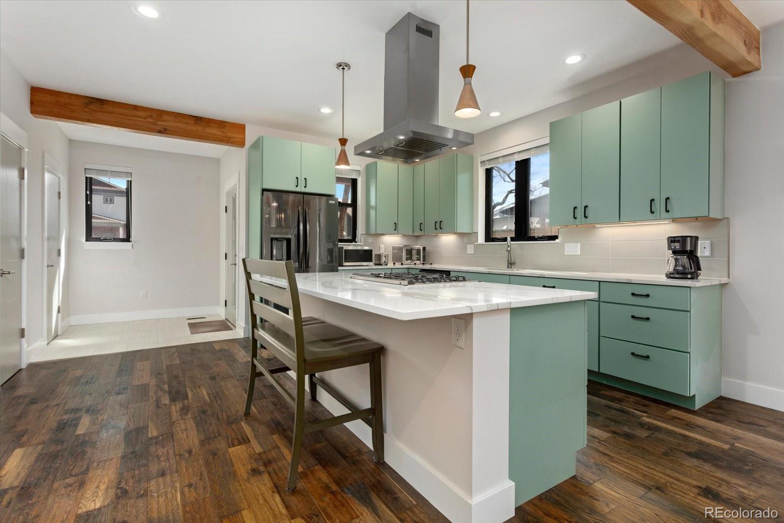 1036 H Street Salida, CO 81201 - Photo 20 of 50 a kitchen with kitchen island granite countertop a sink cabinets and wooden floor
