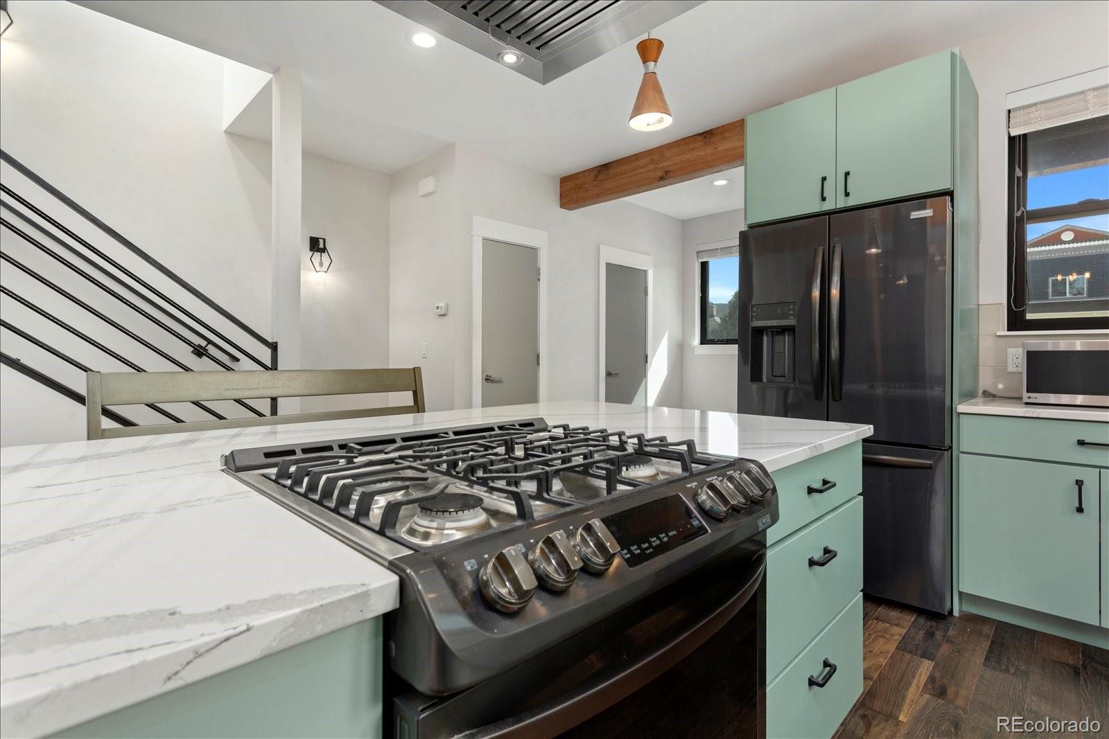 1036 H Street Salida, CO 81201 - Photo 22 of 50 a kitchen with stainless steel appliances granite countertop a stove and a refrigerator