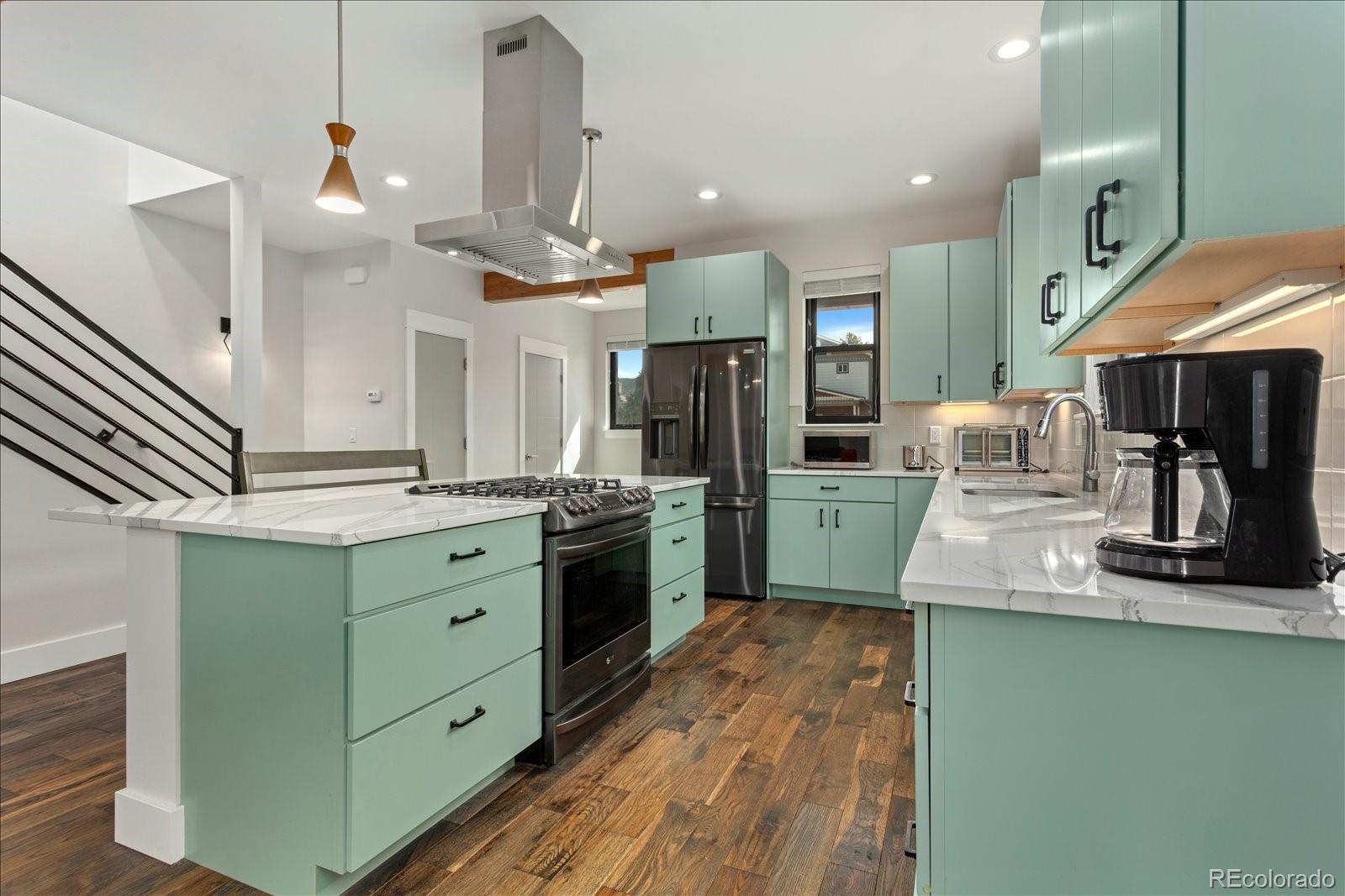 1036 H Street Salida, CO 81201 - Photo 24 of 50 a kitchen with granite countertop a sink cabinets and stainless steel appliances