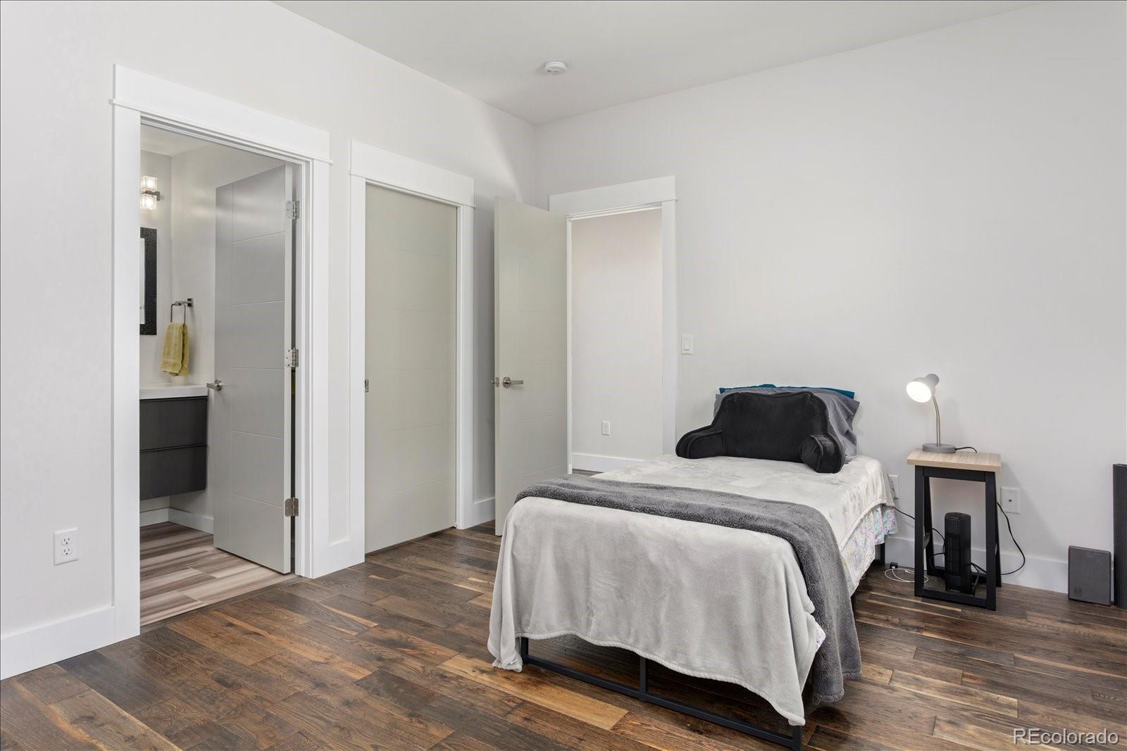 1036 H Street Salida, CO 81201 - Photo 32 of 50 a bedroom with a bed and wooden floor