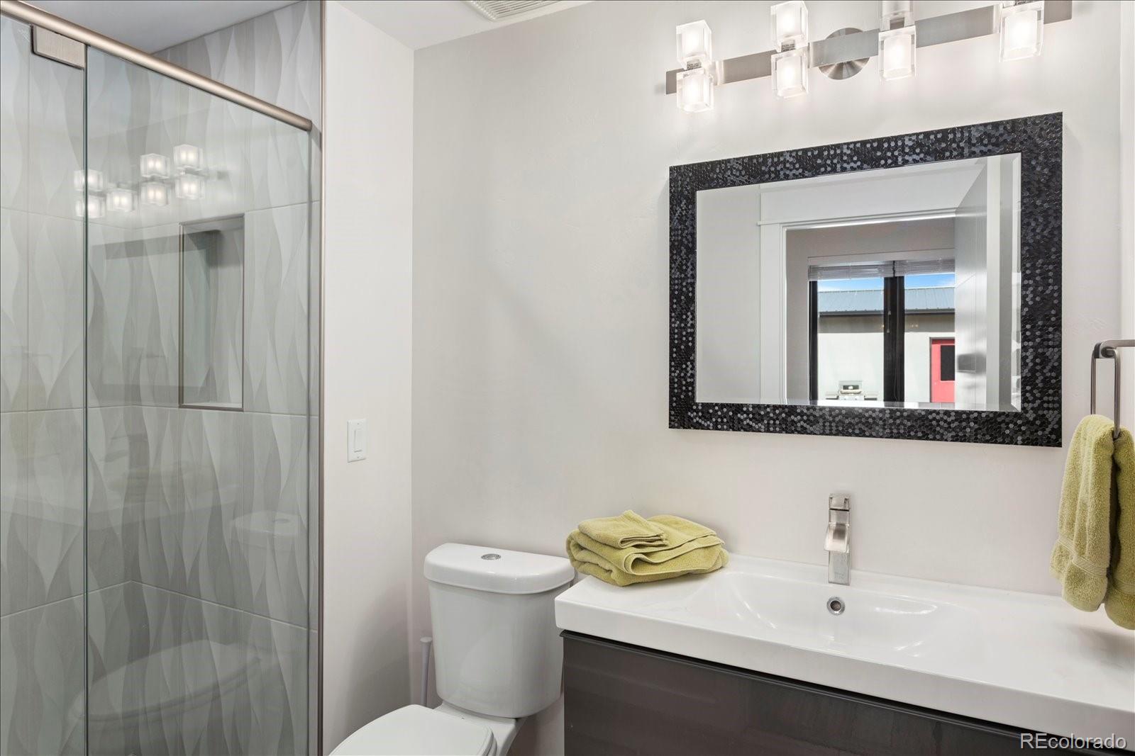 1036 H Street Salida, CO 81201 - Photo 33 of 50 a bathroom with a sink a toilet and shower