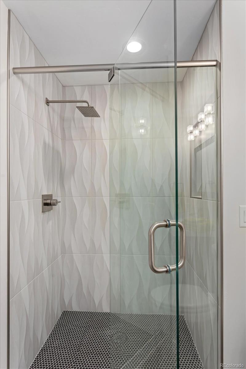 1036 H Street Salida, CO 81201 - Photo 34 of 50 a bathroom with a shower and a glass door shower