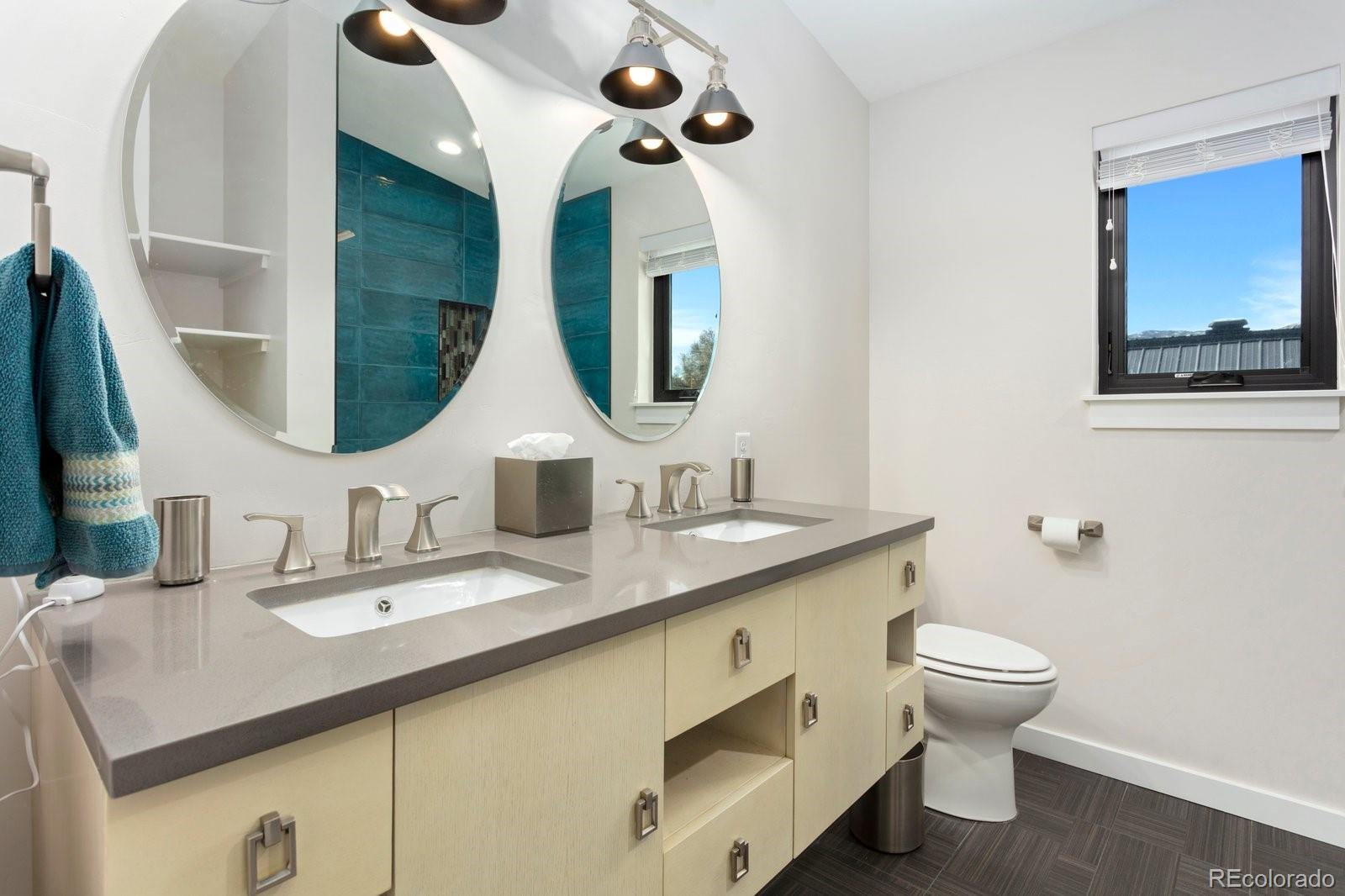 1036 H Street Salida, CO 81201 - Photo 45 of 50 a bathroom with a toilet sink and mirror