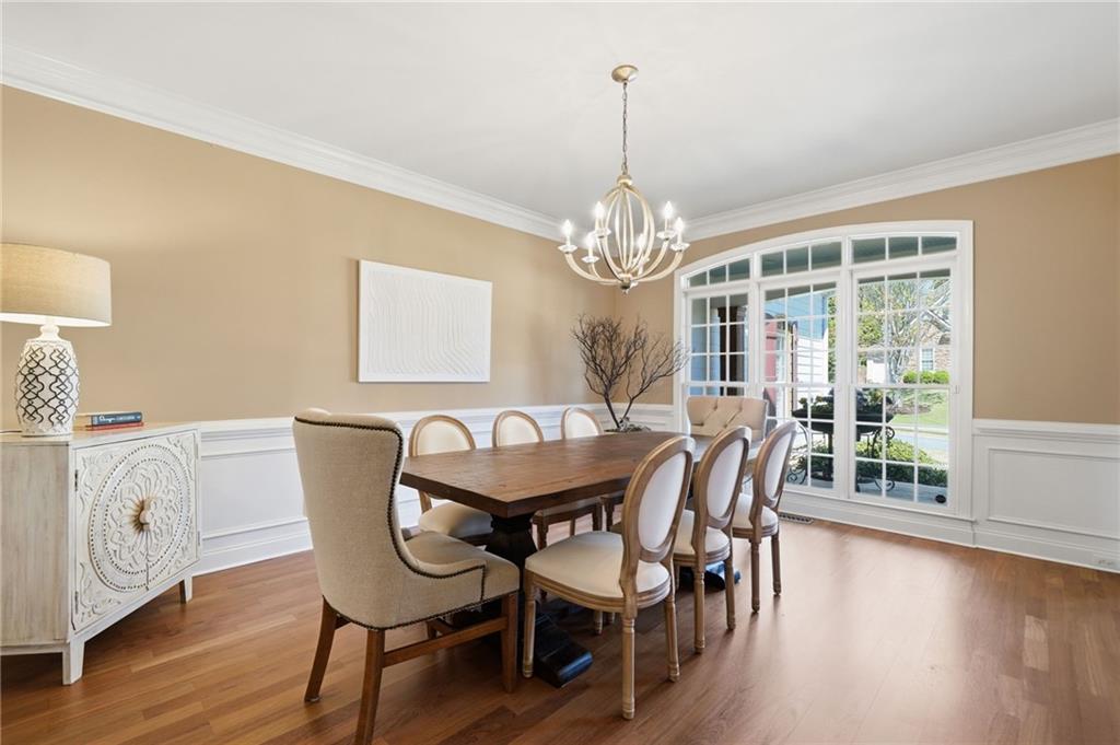 4147 Gold Mill Ridge Canton, GA 30114 - Photo 10 of 93 a view of a dining room with furniture a chandelier and wooden floor