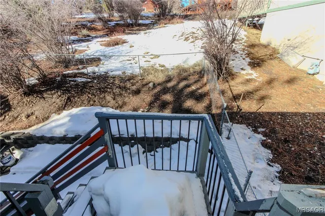 a balcony with wooden floor and trees