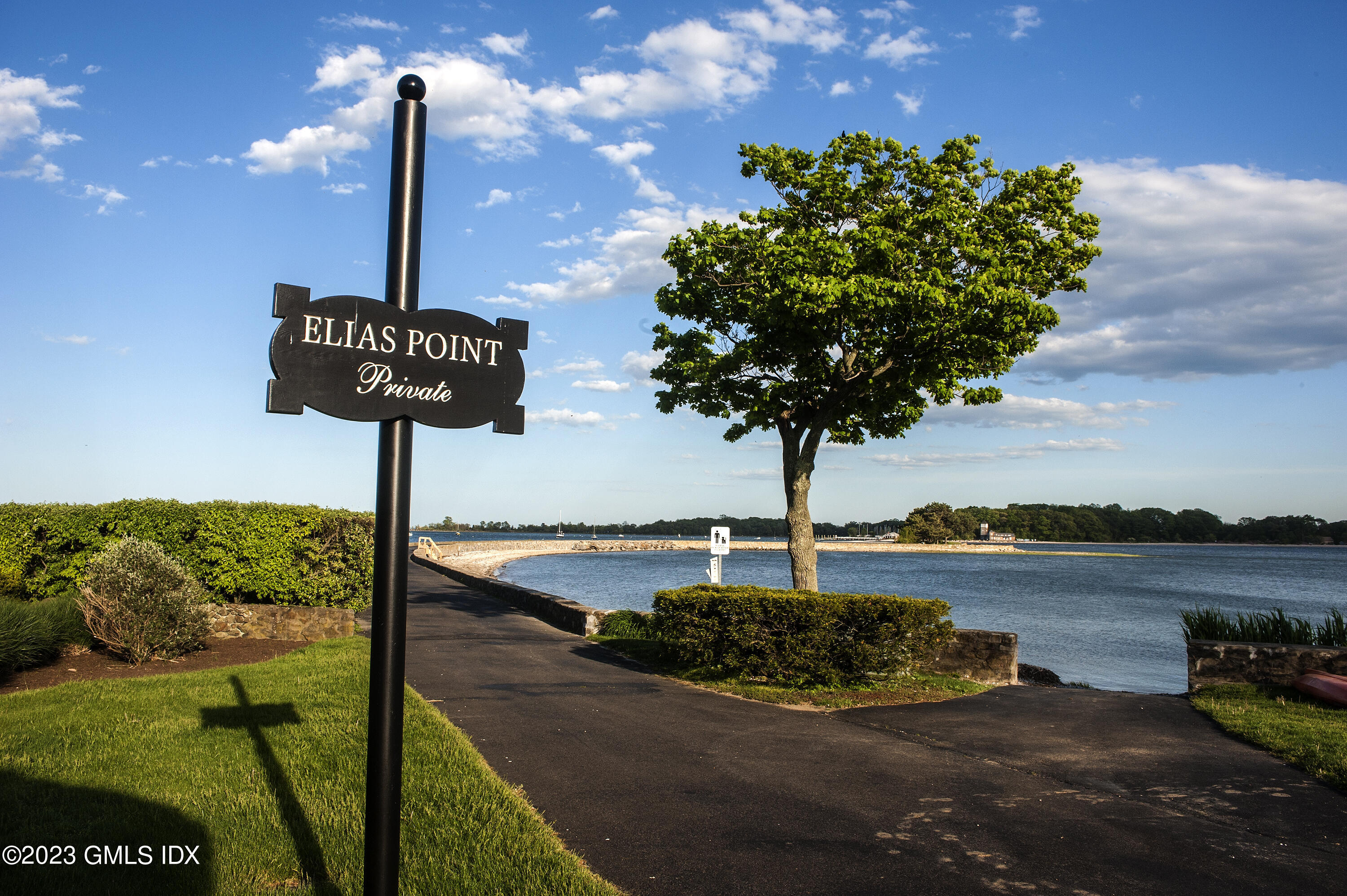 1 Seagate Road Riverside, CT 06878 - Photo 20 of 31 a front view of a street with sign board and lake view