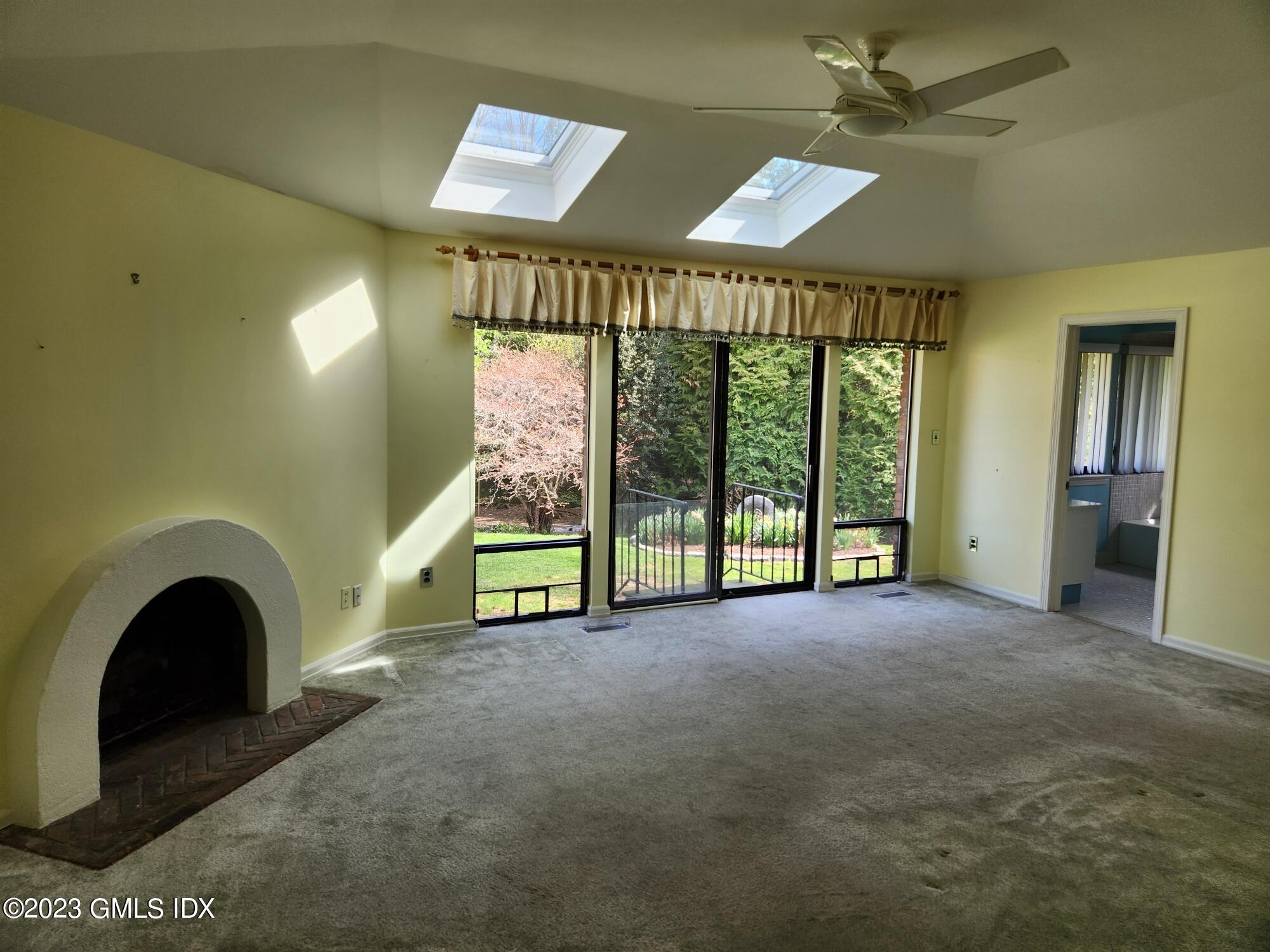 1 Seagate Road Riverside, CT 06878 - Photo 10 of 31 a view of an empty room with a fireplace and a large window