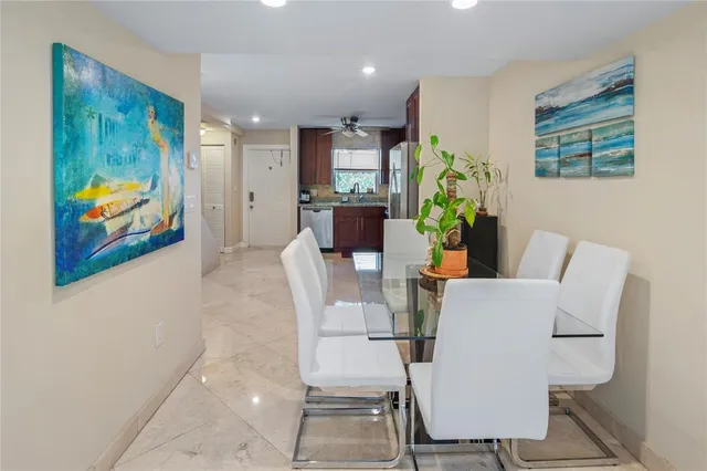 a living room with furniture and a painting on the wall