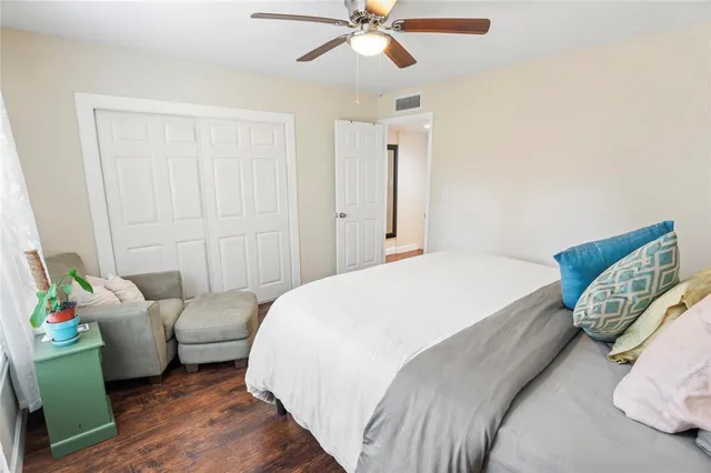 a spacious bedroom with a bed and a window