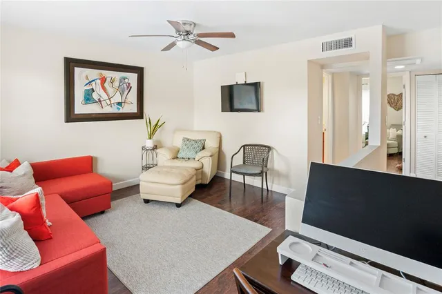 a living room with furniture a couch and a flat screen tv