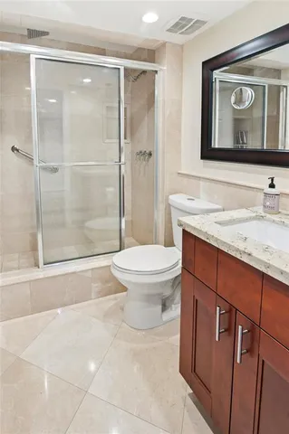 a bathroom with a toilet sink and shower