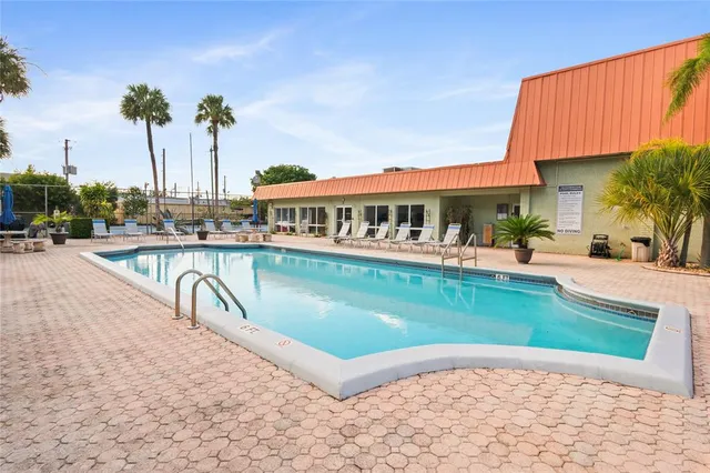 a view of a swimming pool with a table and chairs