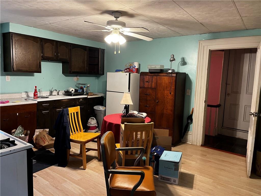 334 Main Street Pittsburgh, PA 15201 - Photo 17 of 24 a living room with stainless steel appliances furniture a refrigerator and a flat screen tv