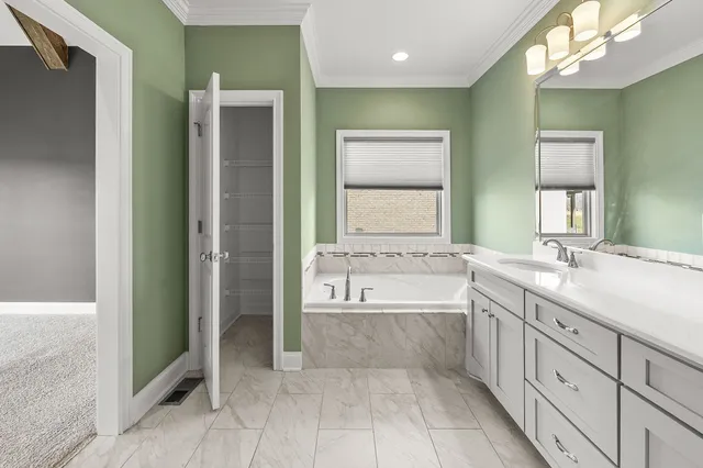 a view of a hallway with wooden cabinets