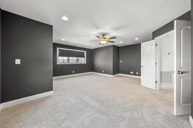 a front view of a brick house with a large window