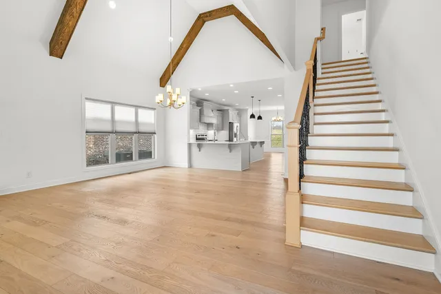 a view of empty room with wooden floor and windows