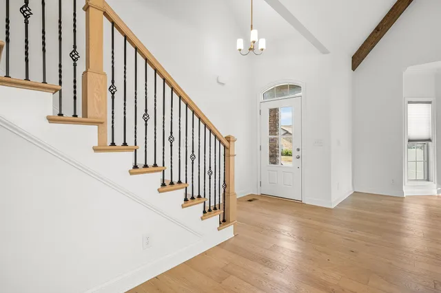 a view of staircase with lots of frames and couches