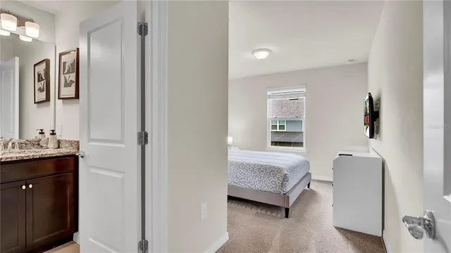 a bathroom with a granite countertop sink a mirror and vanity