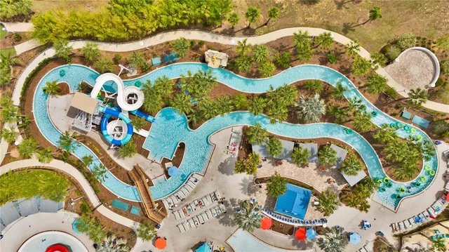 an aerial view of a swimming pool patio and outdoor seating