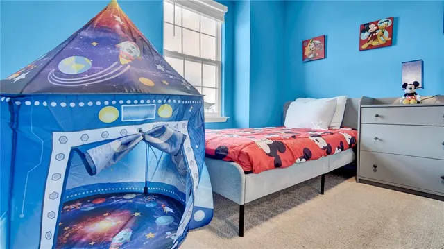 a living room with furniture and wall paintings