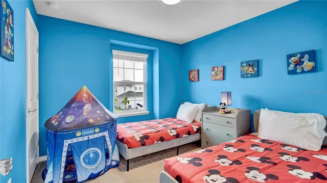 a living room with furniture a couch and a wall painting