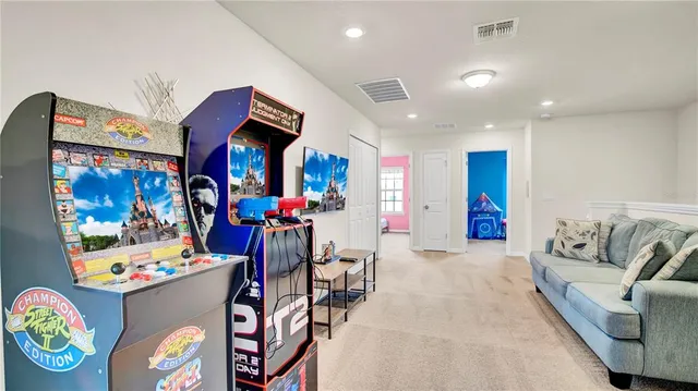 a living room with furniture and kitchen view