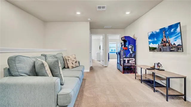 a living room with furniture and kitchen view