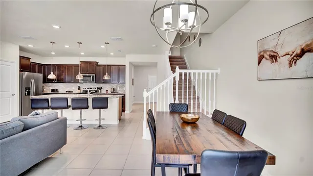 a living room with furniture a rug and kitchen view