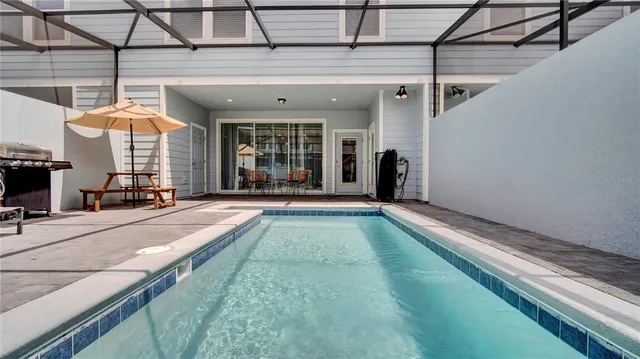 a view of a swimming pool with sitting area