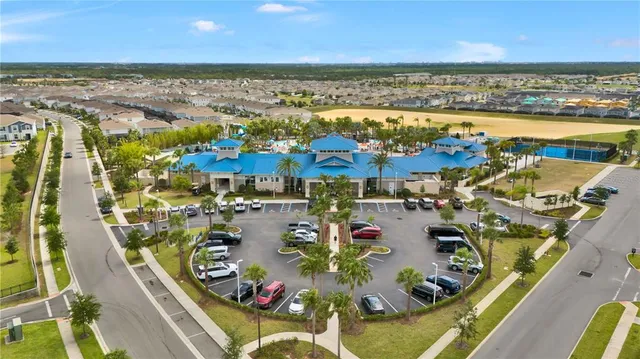 a kitchen with stainless steel appliances granite countertop a stove oven a sink dishwasher and a refrigerator with wooden floor