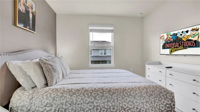 a bedroom with a large bed and a window