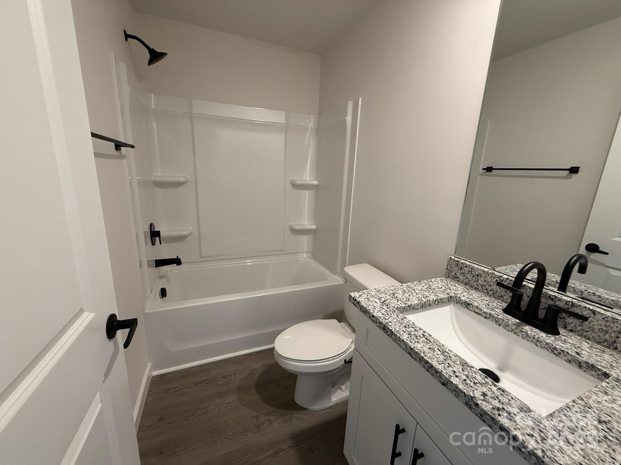 144 33rd Street Northwest, Unit B Hickory, NC 28601 - Photo 9 of 14 a bathroom with a granite countertop sink toilet tub and shower