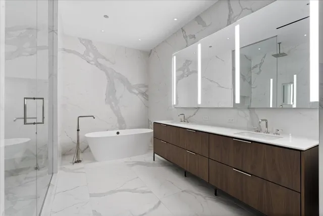 a bathroom with a double vanity sink mirror and shower