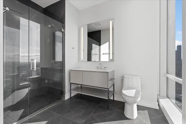 a bathroom with a toilet sink and a mirror
