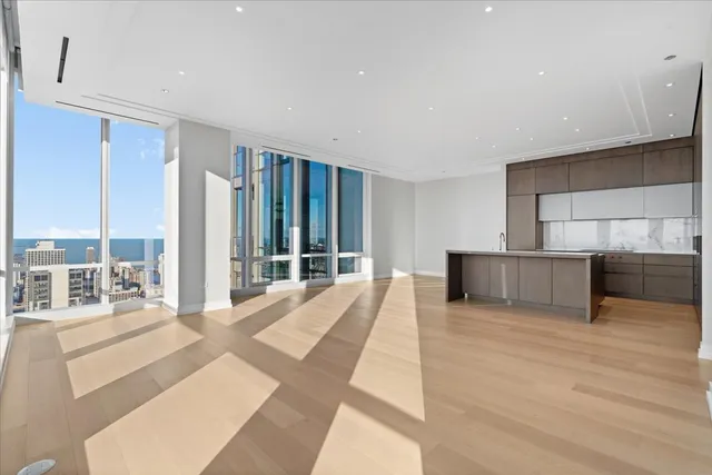 a large bedroom with a large bed and a large window