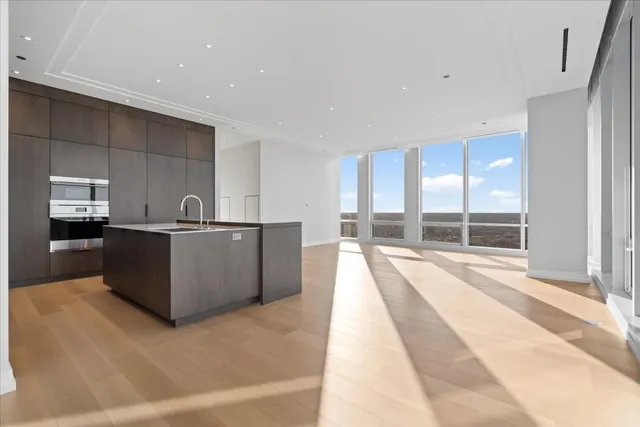 a view of a kitchen with kitchen island and windows