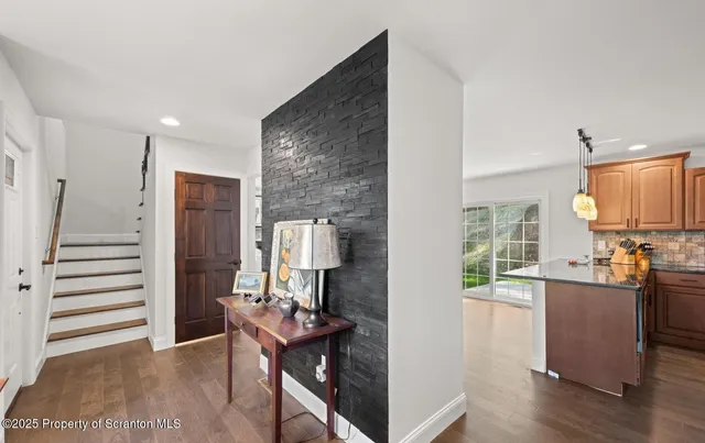 a dining room with furniture a chandelier and wooden floor