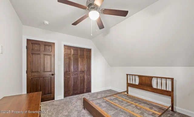 a bed room with a bed and a ceiling fan