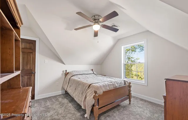 a bedroom with a bed and a ceiling fan