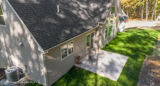a pathway of a house with a yard