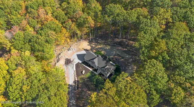 a living room with furniture a flat screen tv and a table