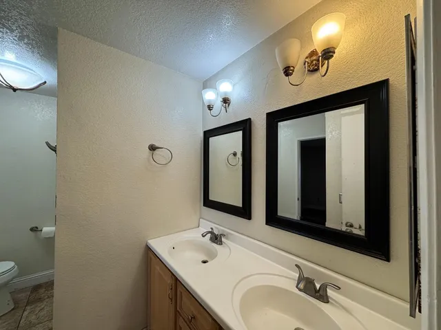 a bathroom with a double vanity sink and a mirror