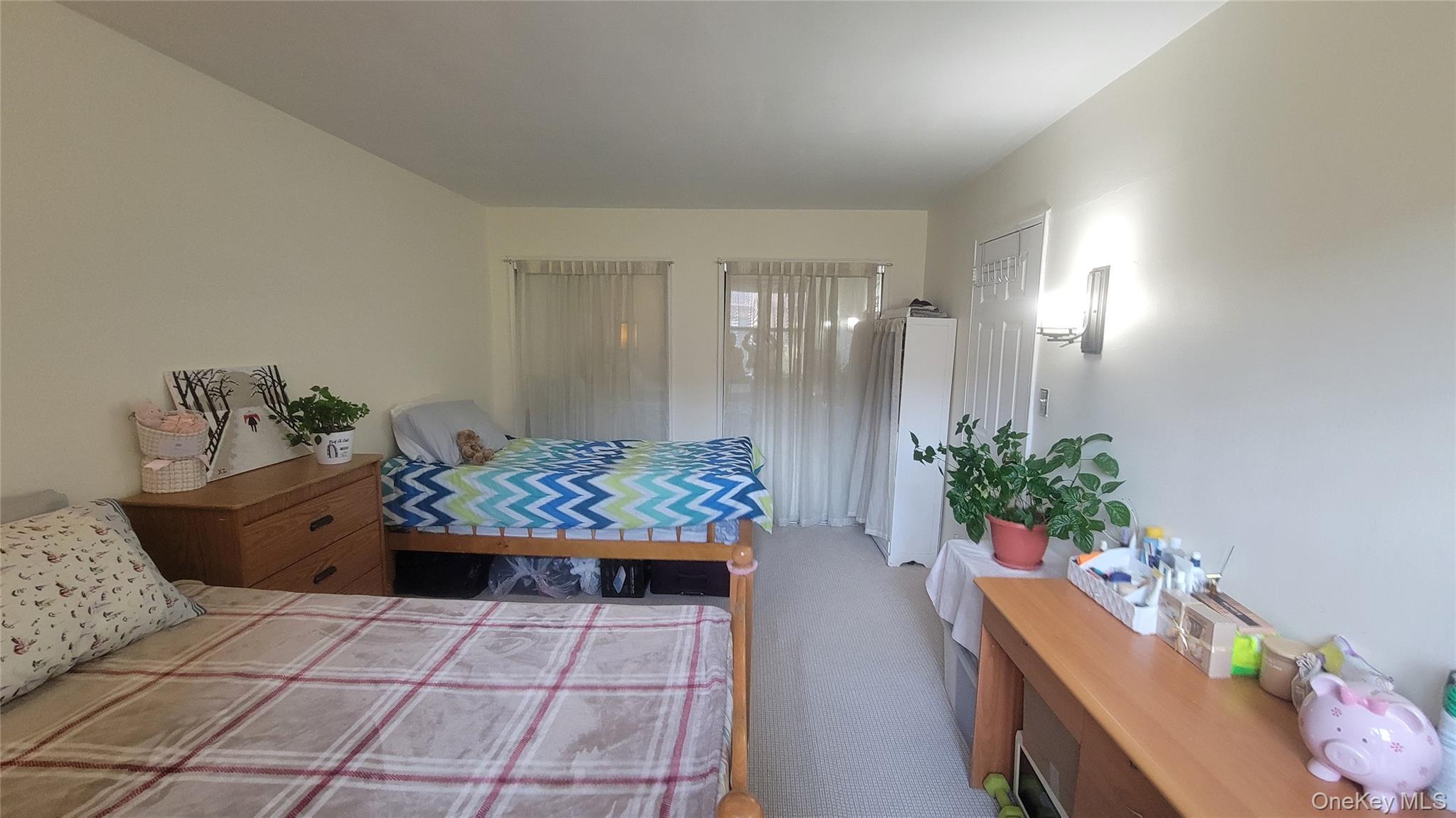 99-30 59th Avenue, Unit 5A Queens, NY 11368 - Photo 4 of 15 a room with furniture and flowers