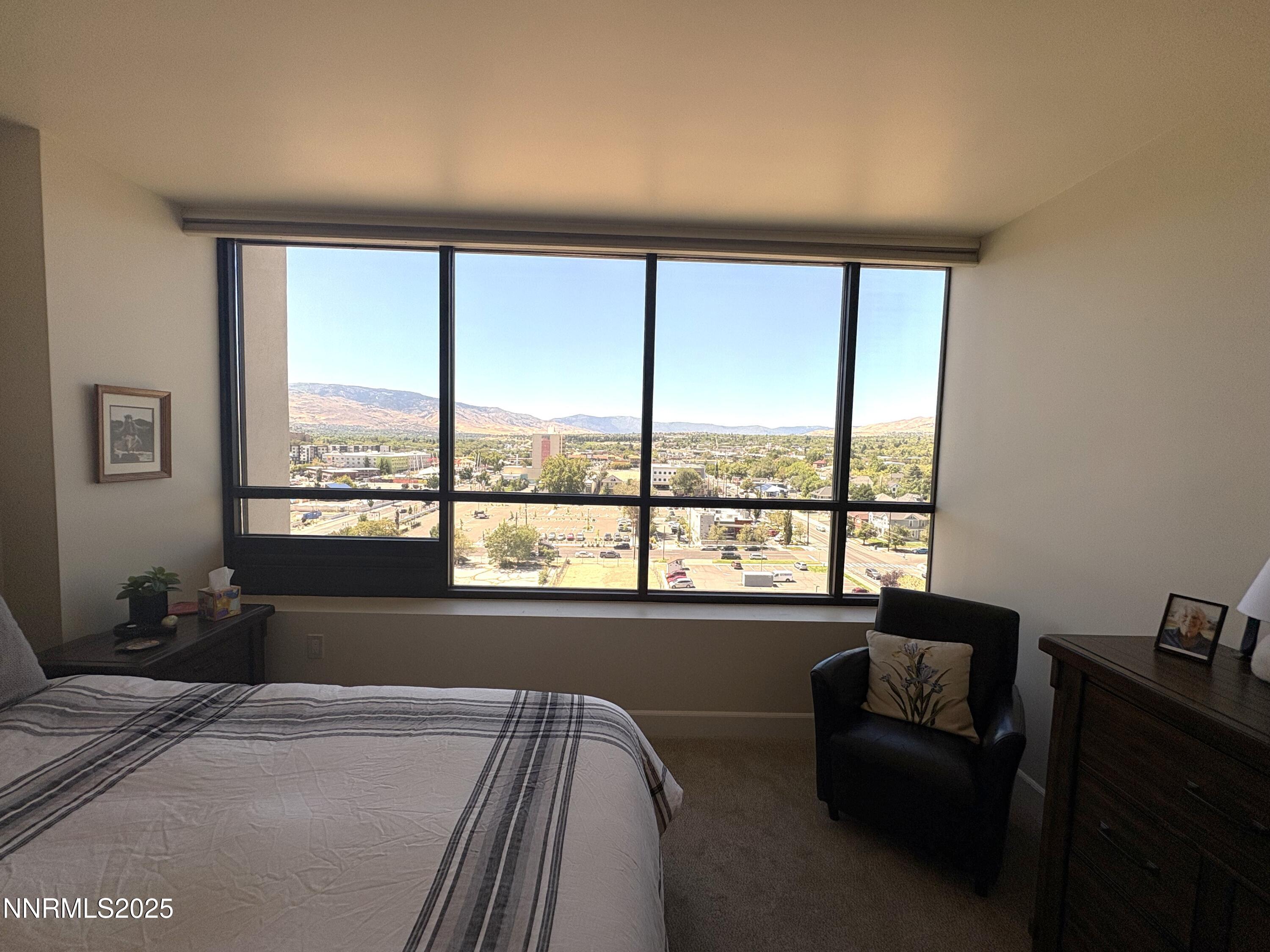 450 North Arlington Avenue, Unit 1207 Reno, NV 89503 - Photo 13 of 21 a bed sitting in a bedroom next to a window