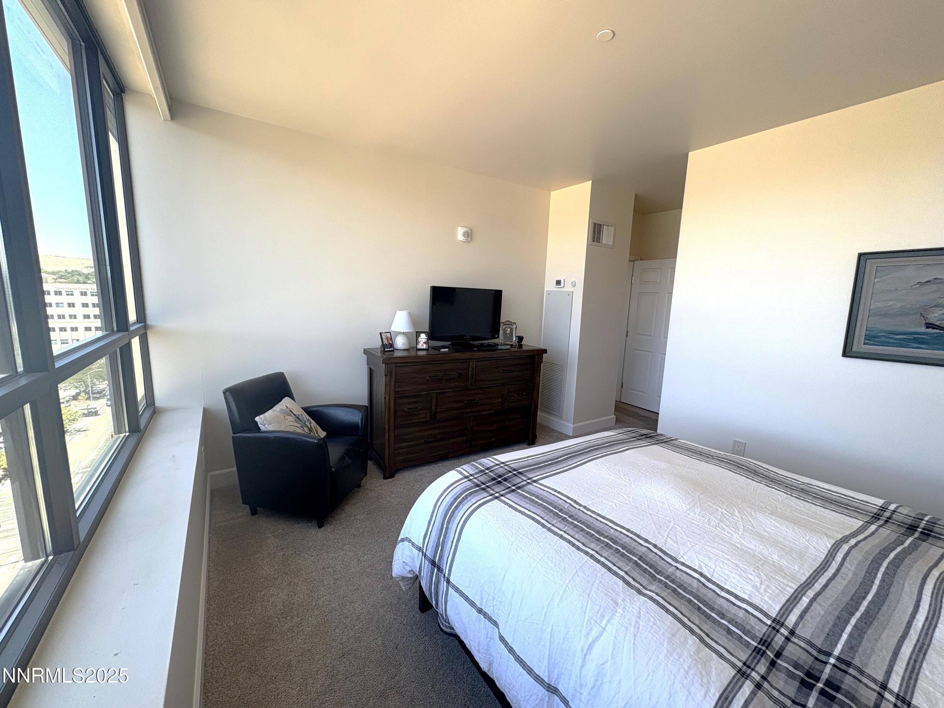 450 North Arlington Avenue, Unit 1207 Reno, NV 89503 - Photo 14 of 21 a bedroom with a bed and wooden floor