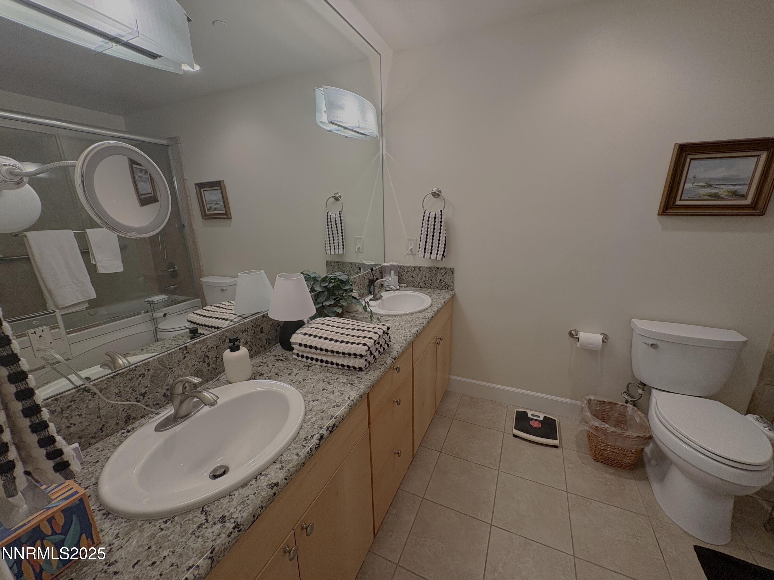 450 North Arlington Avenue, Unit 1207 Reno, NV 89503 - Photo 15 of 21 a bathroom with a granite countertop sink and a mirror