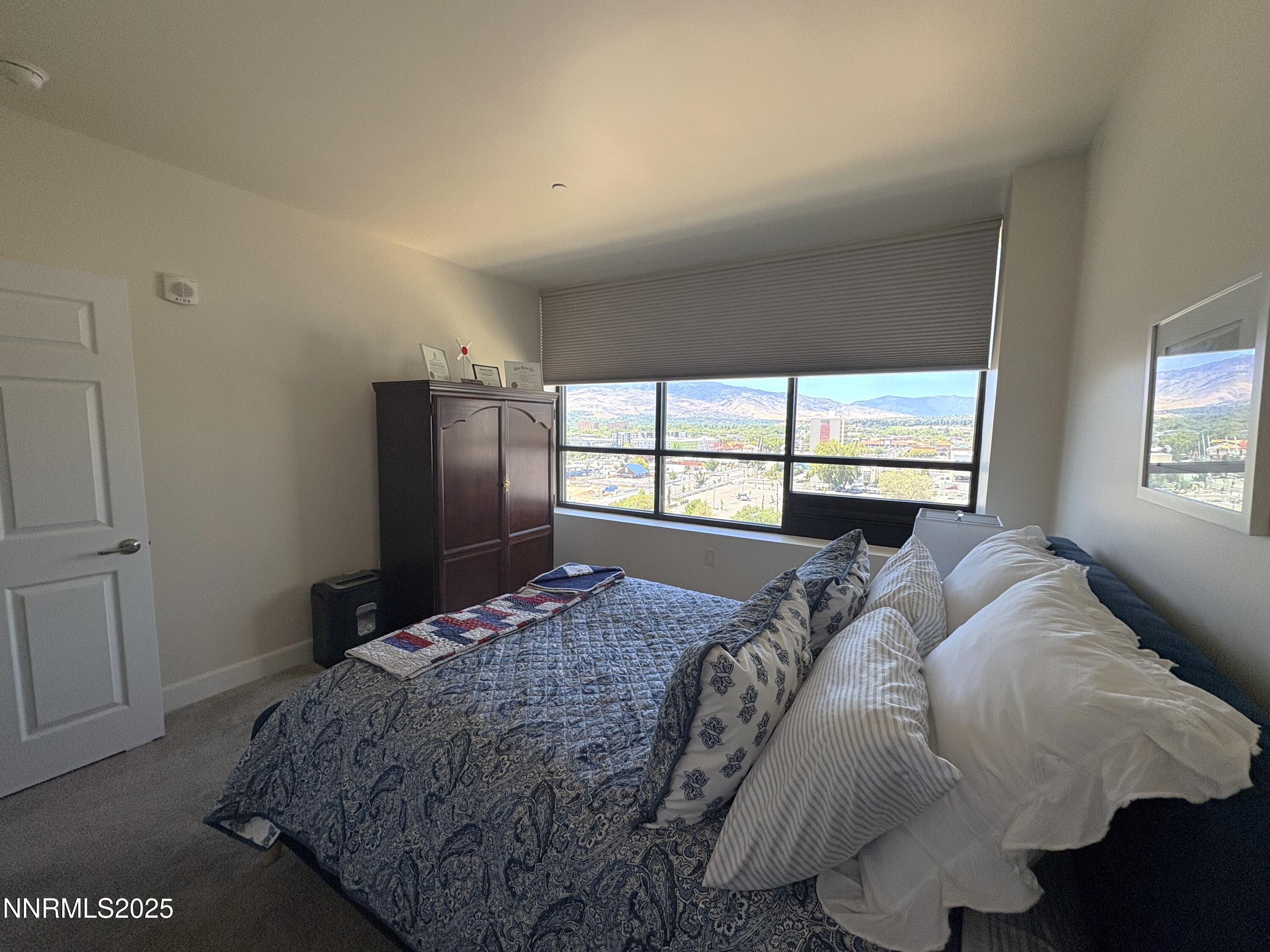 450 North Arlington Avenue, Unit 1207 Reno, NV 89503 - Photo 17 of 21 a bed sitting in a bedroom next to a window