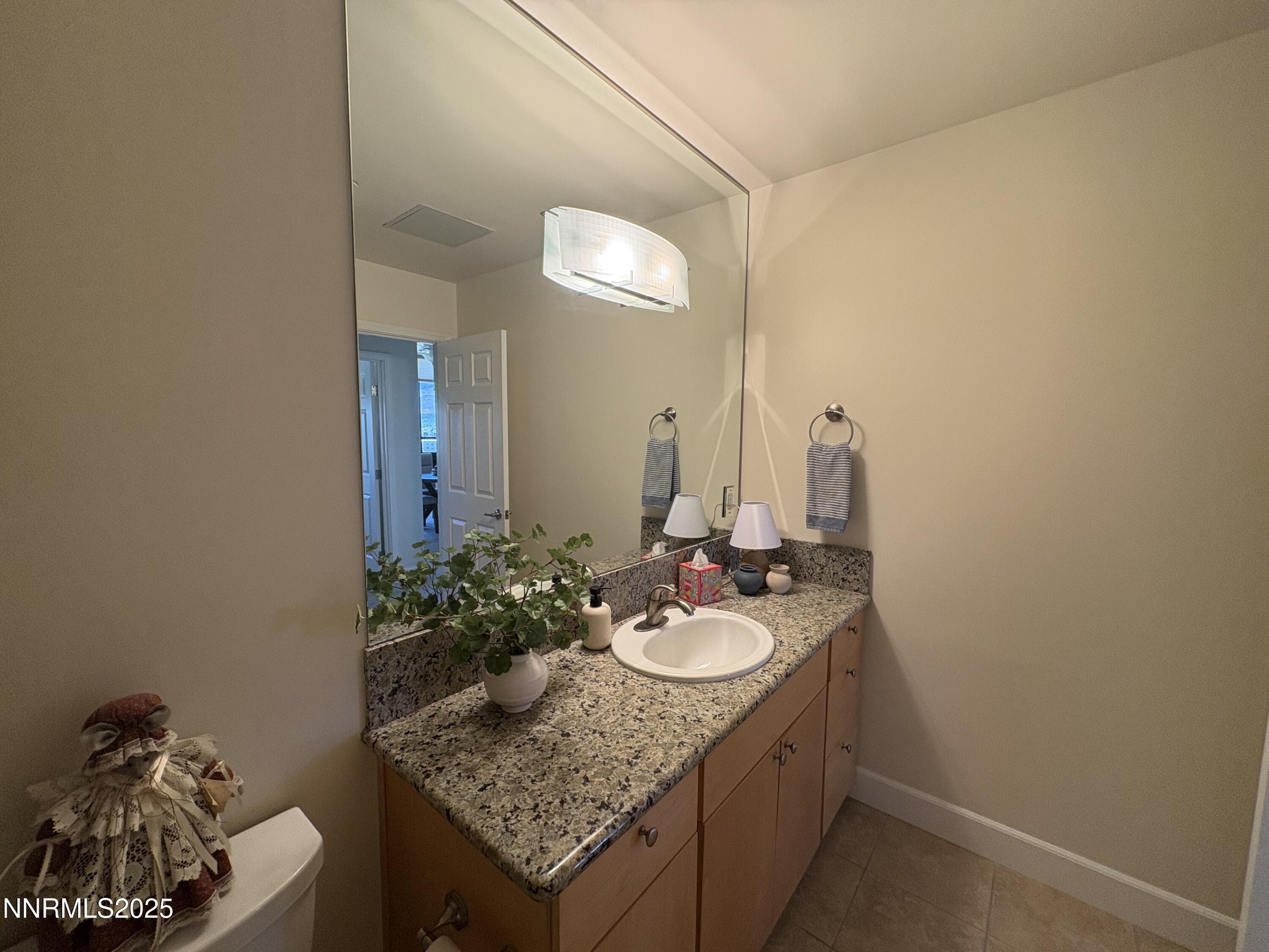 450 North Arlington Avenue, Unit 1207 Reno, NV 89503 - Photo 20 of 21 a bathroom with a granite countertop sink and a mirror